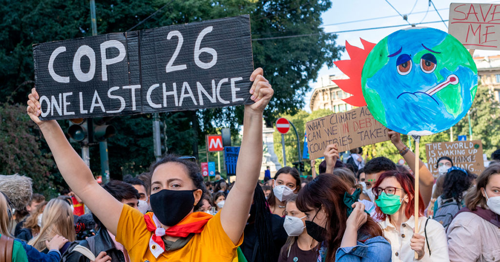 Climate protester with COP26 sign