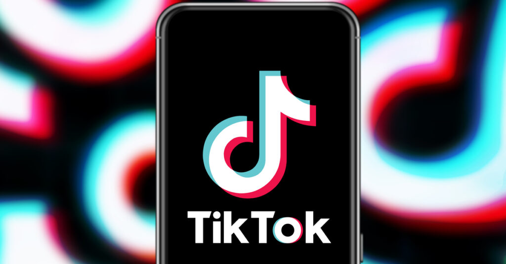 Tiktok logo on phone against background of repeated Tiktok logos