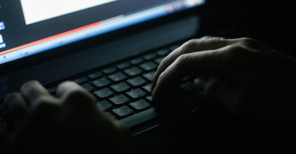 hands using computer keyboard with dark shadow effect