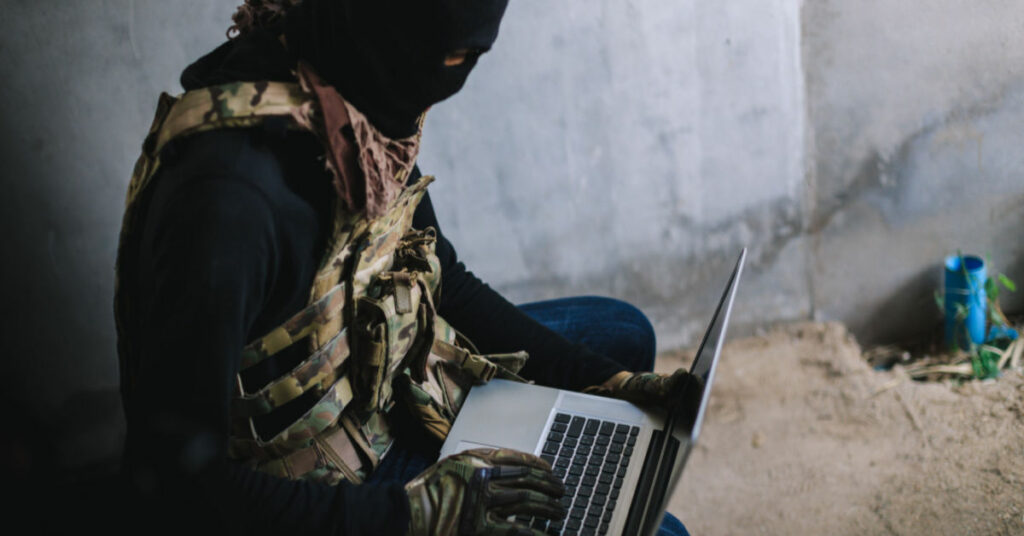 Terrorist actor using laptop