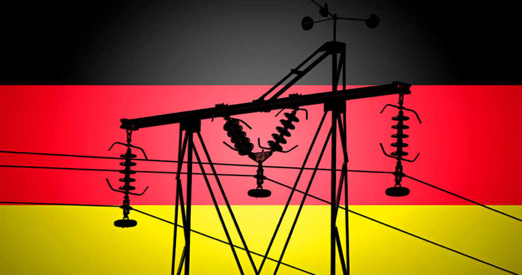 Concept Illustration With German Flag in the Background And old power line Silhouette in the foreground symbol for the upcoming energy crisis.