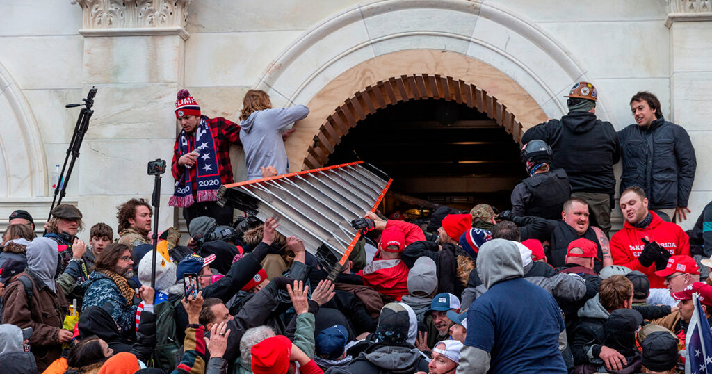 Rioters clash with police trying to enter Capitol building through the front doors on January 6th, 2021.