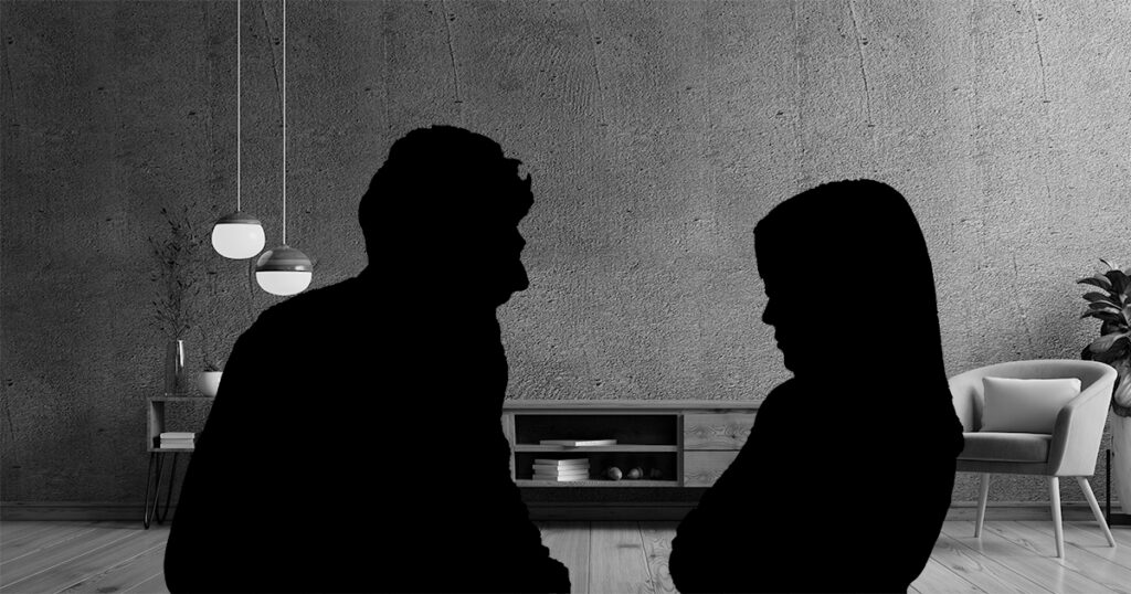 Silhouette of a couple fighting with a living room in the background.